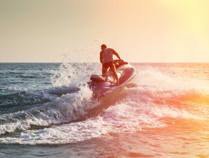 Silhouette,Of,Strong,Man,Jumps,On,The,Jetski,Above,The