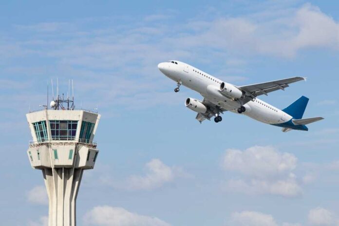 Air,Control,Tower,And,Airplane,On,Blue,And,Cloudy,Sky