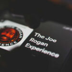 Phone screen displaying The Joe Rogan Experience logo.