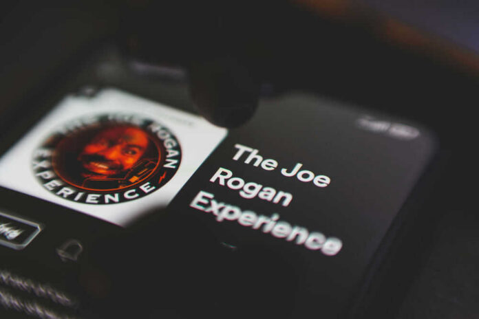 Phone screen displaying The Joe Rogan Experience logo.