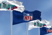 Four flags with NFL and Super Bowl LVII logos.