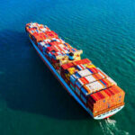 Cargo ship carrying colorful containers on ocean