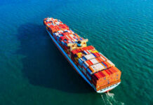 Cargo ship carrying colorful containers on ocean