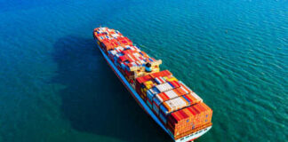 Cargo ship carrying colorful containers on ocean