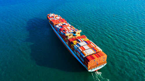 Cargo ship carrying colorful containers on ocean