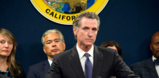 Person speaks at podium with California seal behind.