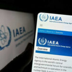 IAEA website displayed on smartphone screen.