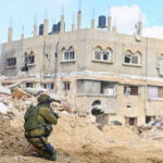 Israeli Troops Accused of Attacking CNN Crew Soldier crouching near building in a wartorn area