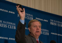 Man holding phone at National Press Club event