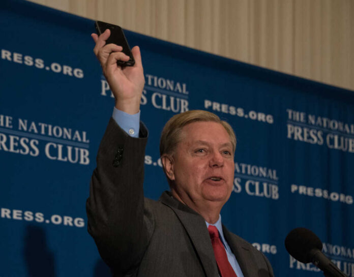 Man holding phone at National Press Club event