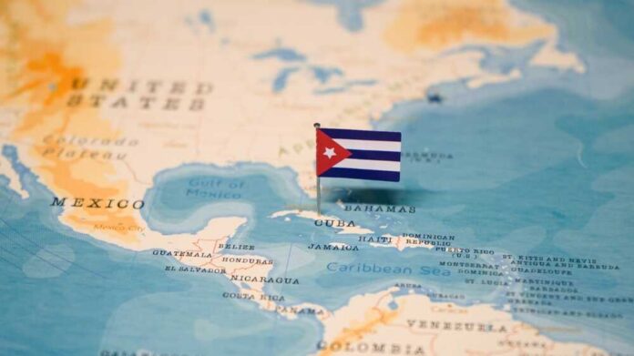 shutterstock_2325781039.jpg Map of the Caribbean with a small Cuban flag pinned on Cuba