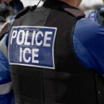 Airport Security MELTDOWN – ICE Plan Sparks Fear Close-up of a police officer's vest with 'POLICE ICE' label