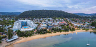 Beachfront town with buildings boats and surrounding hills