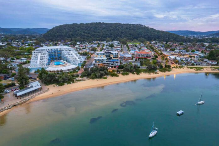 Beachfront town with buildings boats and surrounding hills