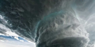 Massive storm cloud over open field sky threatening