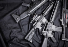 Black rifles on a dark fabric background