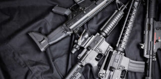 Black rifles on a dark fabric background