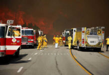 California Snowpack CRISIS – Fire Season Looms Firefighters battling large wildfire with fire trucks present