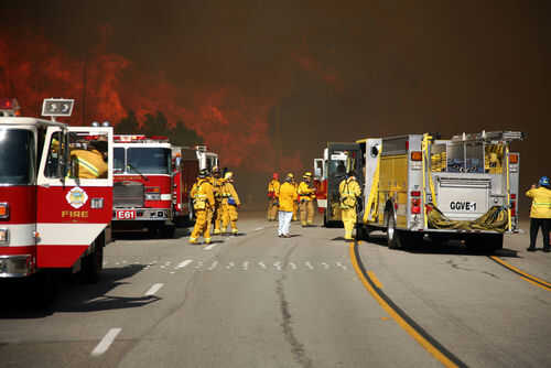 california-fire-fighter20701837 Firefighters battling large wildfire with fire trucks present