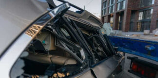 Damaged car with smashed rear window on street