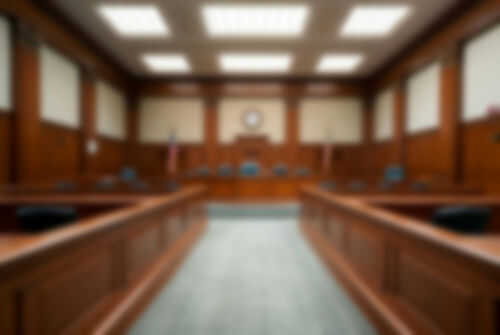 courtroom2324977165 Blurred view of a courtroom with wooden furnishings