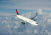 Delta Air Lines airplane flying above the clouds