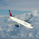 Delta Air Lines airplane flying above the clouds