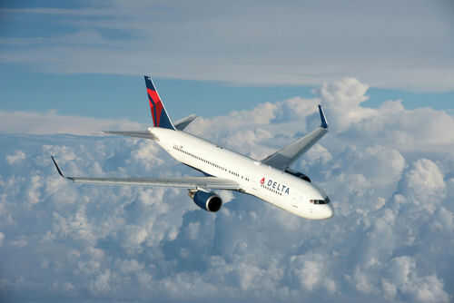 Delta Air Lines airplane flying above the clouds