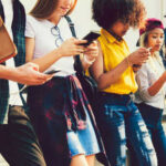 Gen Z Artists Ditch Tech Giants for Snail Mail Group of young people looking at smartphones