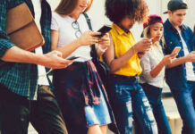 Group of young people looking at smartphones