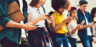 Group of young people looking at smartphones