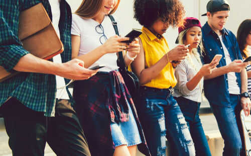 Group of young people looking at smartphones