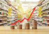 Rising graph over stacked coins in grocery store