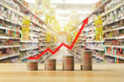 Rising graph over stacked coins in grocery store