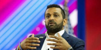 Person speaking on stage with colorful background