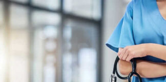 Healthcare professional holding a stethoscope in hospital