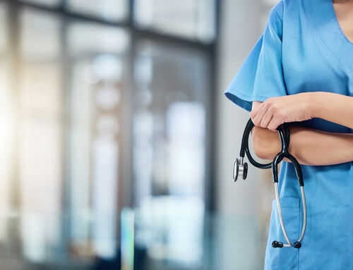 Healthcare professional holding a stethoscope in hospital