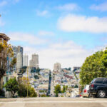 City street view with buildings and parked cars