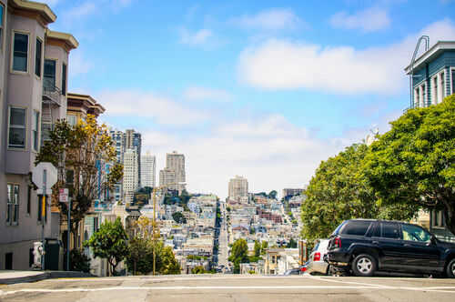 City street view with buildings and parked cars