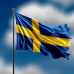 Waving flag of Sweden against a blue sky