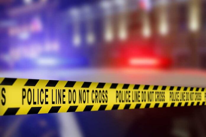 Yellow police caution tape with the text 'POLICE LINE DO NOT CROSS' in a blurred background