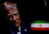 TRUMP DELIVERS: Airman Escapes Iran’s Grasp Close-up portrait of a man with a serious expression, with the Iranian flag in the background