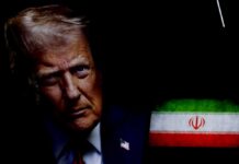 TRUMP DELIVERS: Airman Escapes Iran’s Grasp Close-up portrait of a man with a serious expression, with the Iranian flag in the background