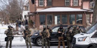 Law enforcement officers in tactical gear at a crime scene in winter