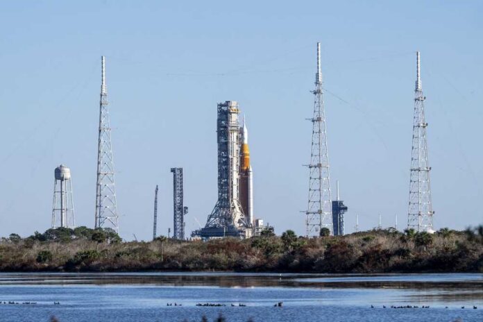 shutterstock_2746627781.jpg Rocket on the launch pad surrounded by communication towers and water