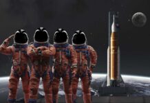 NASA’s Artemis II Crew Faces 40-Minute Isolation Four astronauts in orange suits standing in front of a rocket with the moon in the background