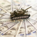 Toy tank on spread out dollar bills