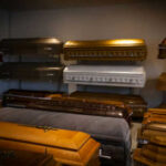 Coffins on display in a showroom.