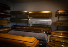 12-Day Decomposition Scandal Rocks Funeral Home Coffins on display in a showroom.