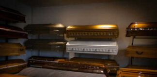 Coffins on display in a showroom.
